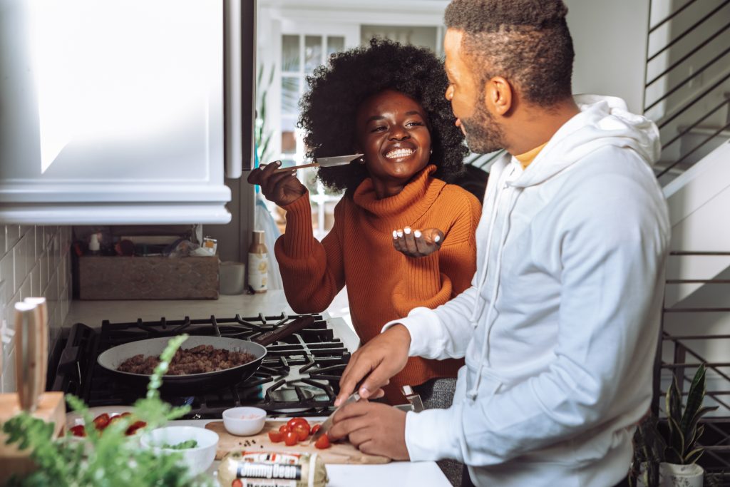 man and woman cooking food together - healthy lifestyles