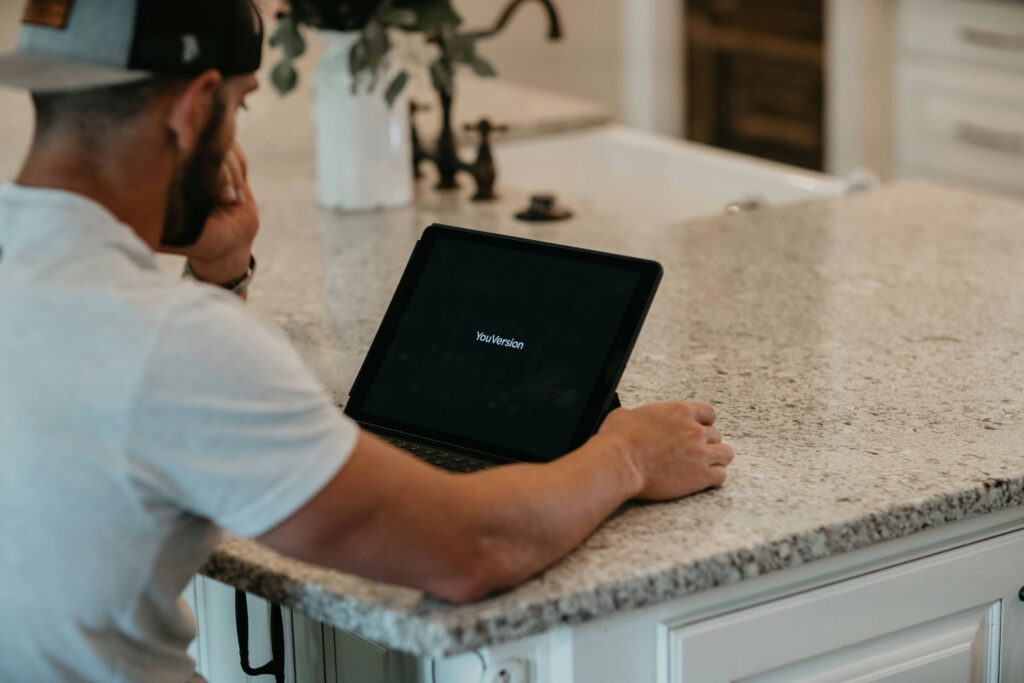 man staring at a tablet computer - computer-based psychological intervention